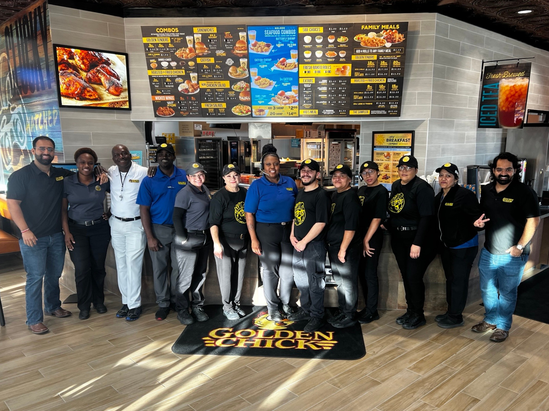 New Golden Chick Houston team members celebrate the opening of the new store