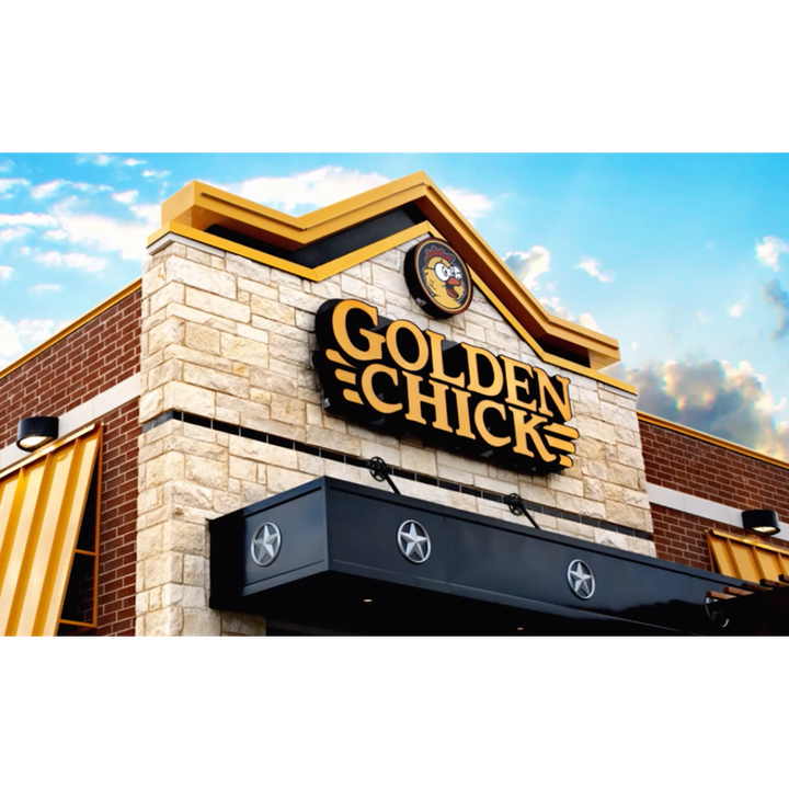 Exterior of a Golden Chick QSR franchise restaurant with a stone and brick facade, yellow accents, and a logo featuring a chicken. The building has a prominent sign with the restaurant's name.
